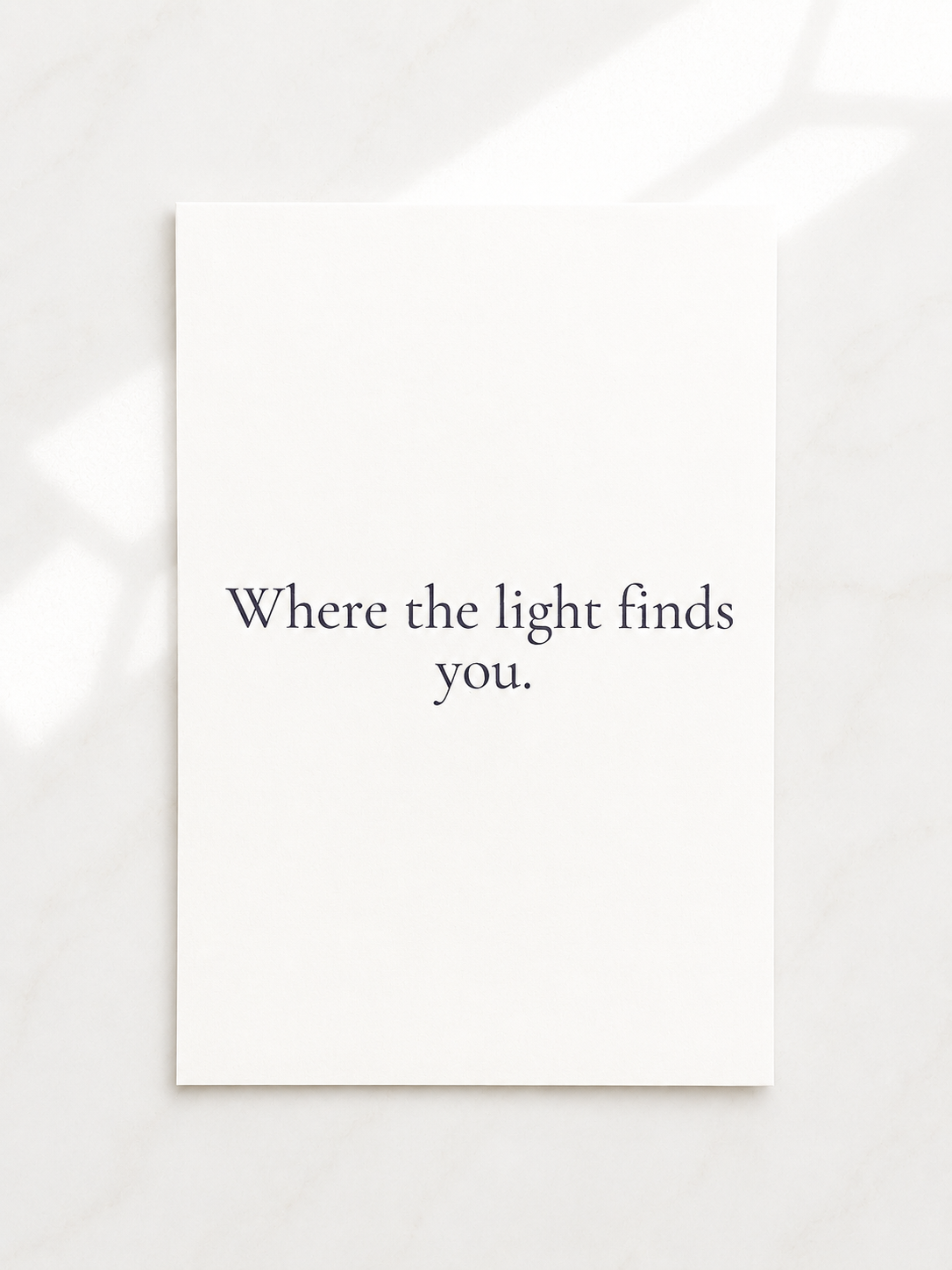 White frame with black text 'Where the light finds you.' on a white background