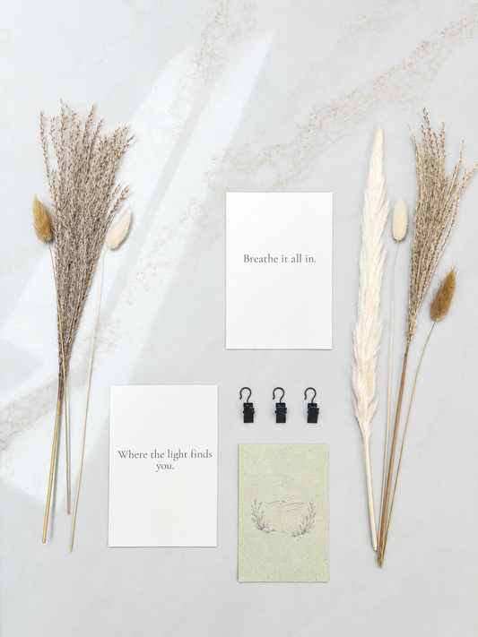 Decorative elements including dried plants and motivational cards on a light background